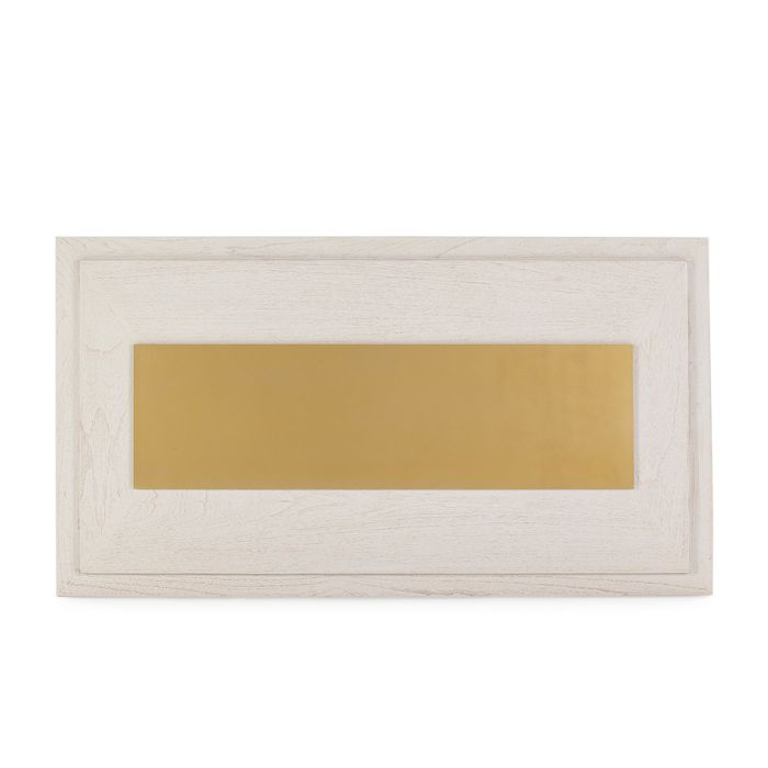 Cabecero art decó en madera blanca con panel central de metal dorado.